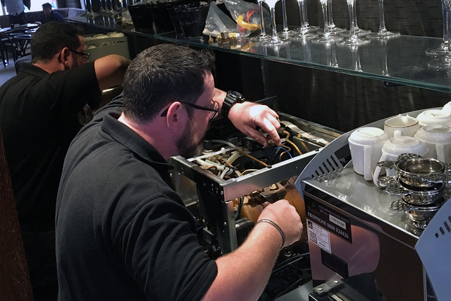 Engineer fixing coffee machine